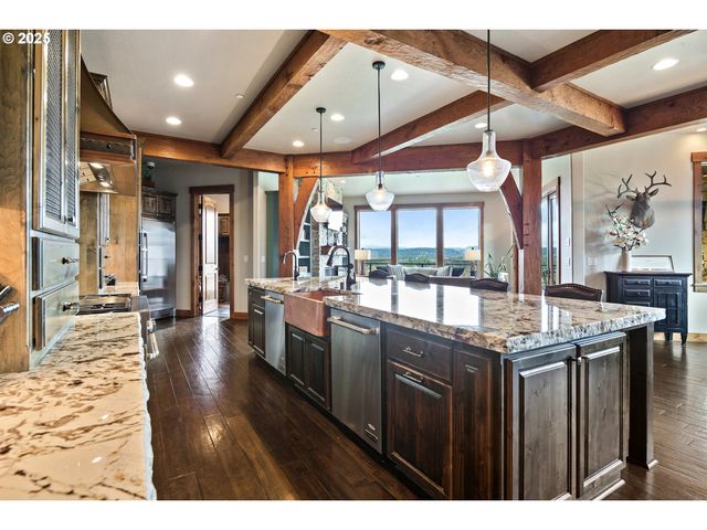 a kitchen with stainless steel appliances granite countertop a stove and cabinets