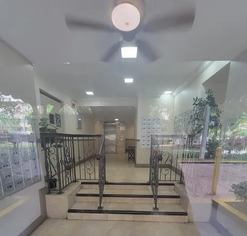 a kitchen with a sink a microwave a refrigerator and cabinets