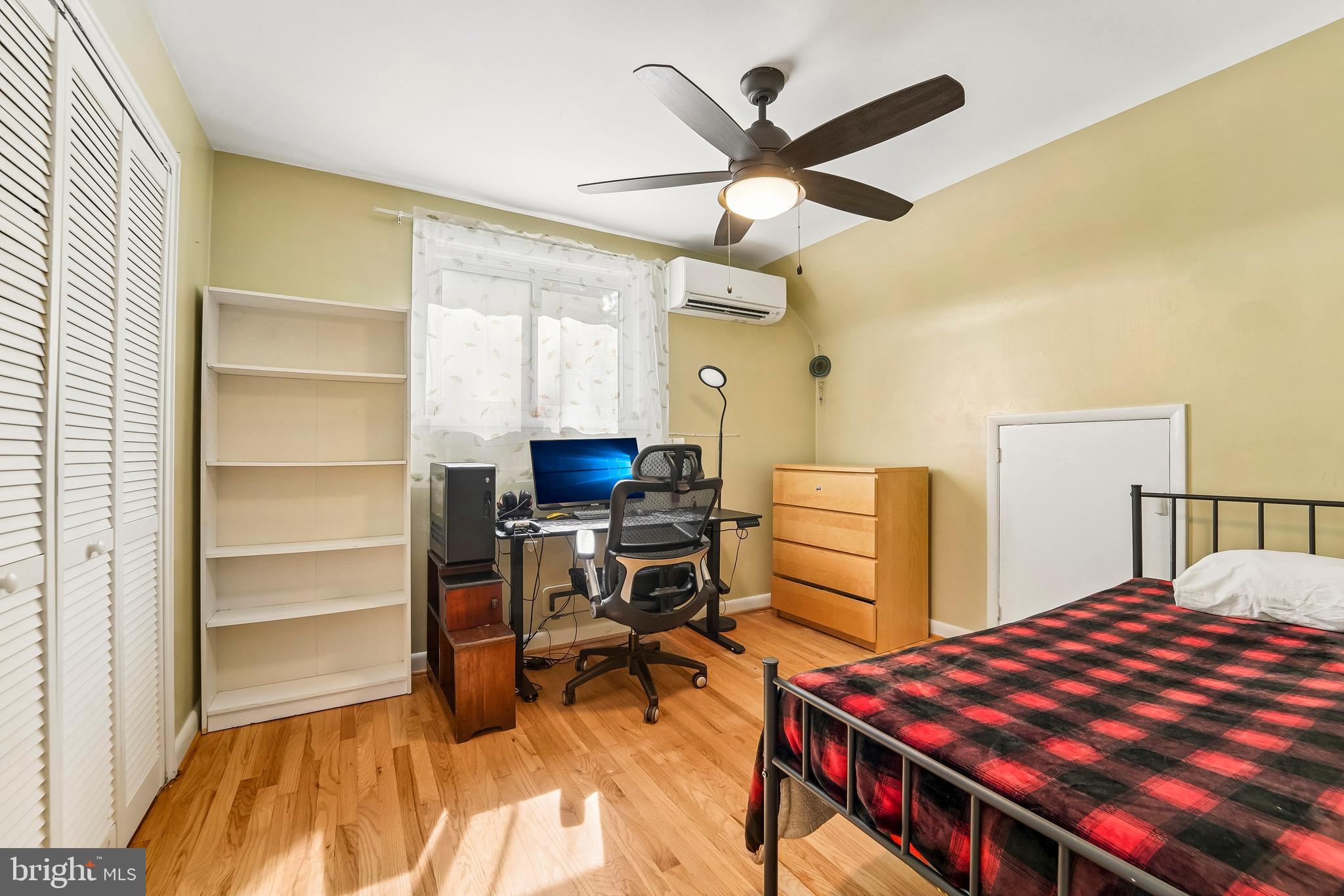 6640 Loch Hill Road Baltimore, MD 21239 - Photo 20 of 35 a bedroom with a bed and a chandelier