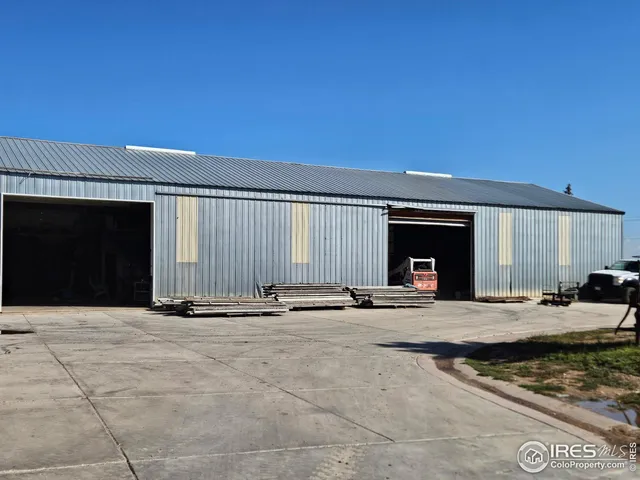 a backyard of a house with barbeque oven table and chairs