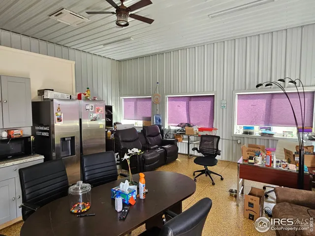 a living room with lots of chairs and a chandelier