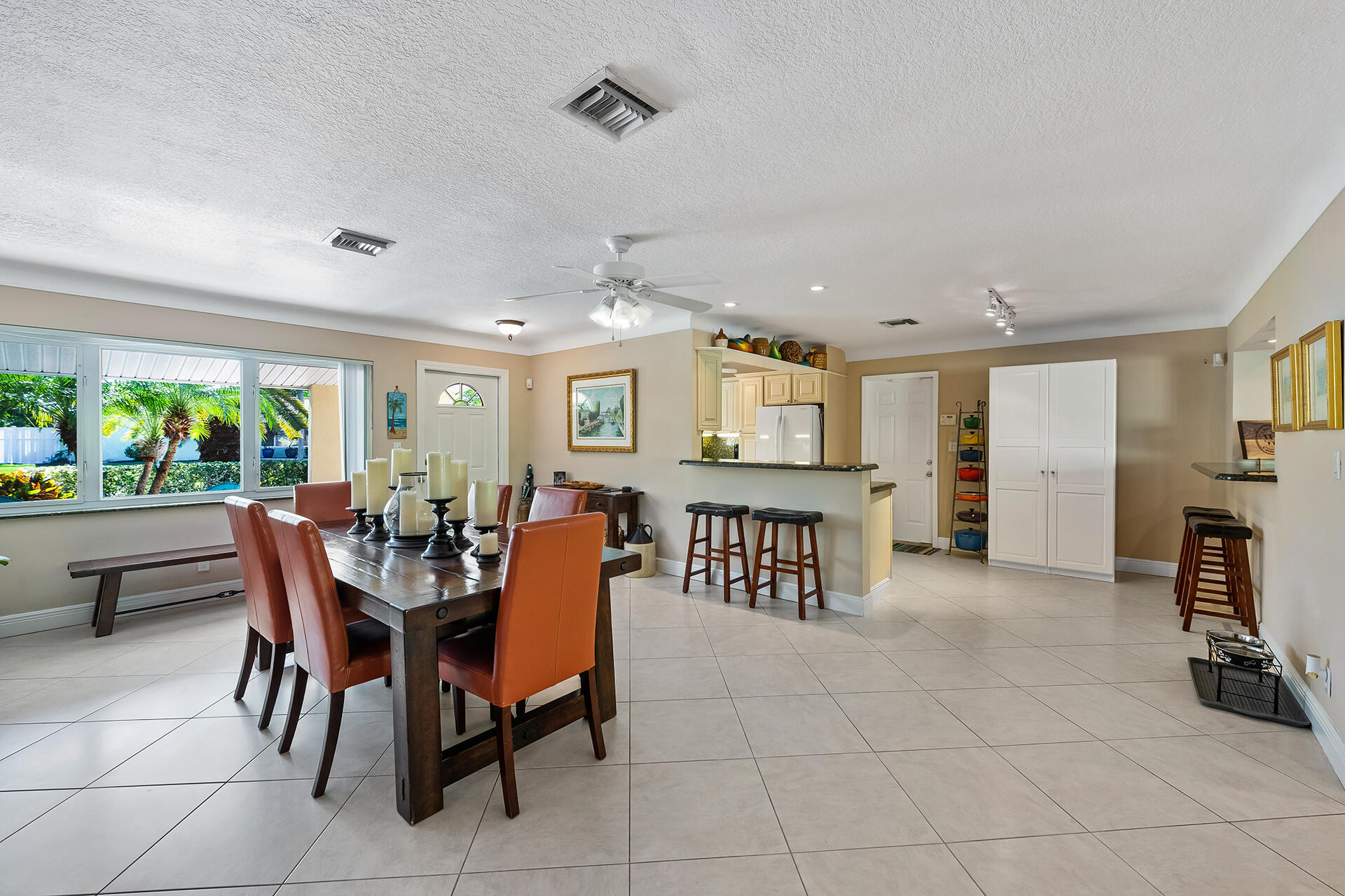 2251 Northeast 37th Court Lighthouse Point, FL 33064 - Photo 5 of 26 a view of a dining room with furniture and a floor to ceiling window