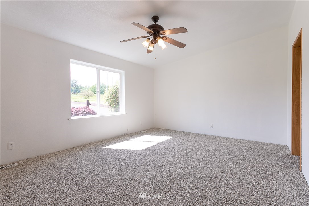 9690 Delta Line Road Blaine, WA 98230 - Photo 14 of 38 an empty room with windows and fan