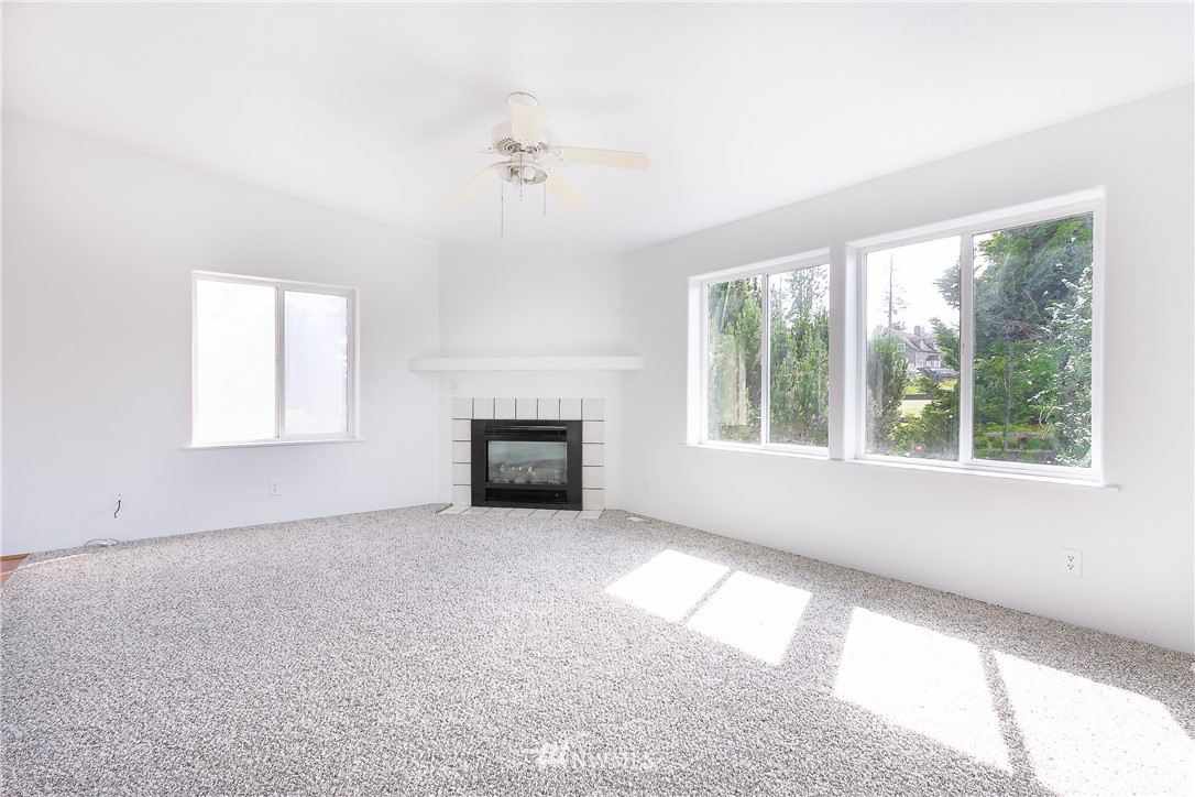 9690 Delta Line Road Blaine, WA 98230 - Photo 4 of 38 an empty room with windows and fireplace