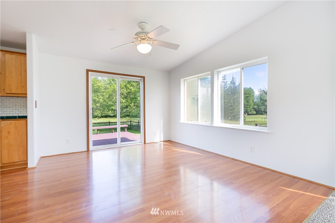 9690 Delta Line Road Blaine, WA 98230 - Photo 5 of 38 a view of an empty room with wooden floor and a window