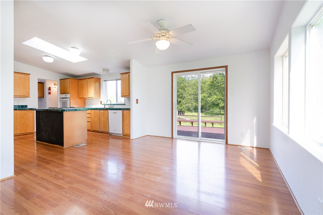 9690 Delta Line Road Blaine, WA 98230 - Photo 7 of 38 a view of a kitchen with wooden floor and a window