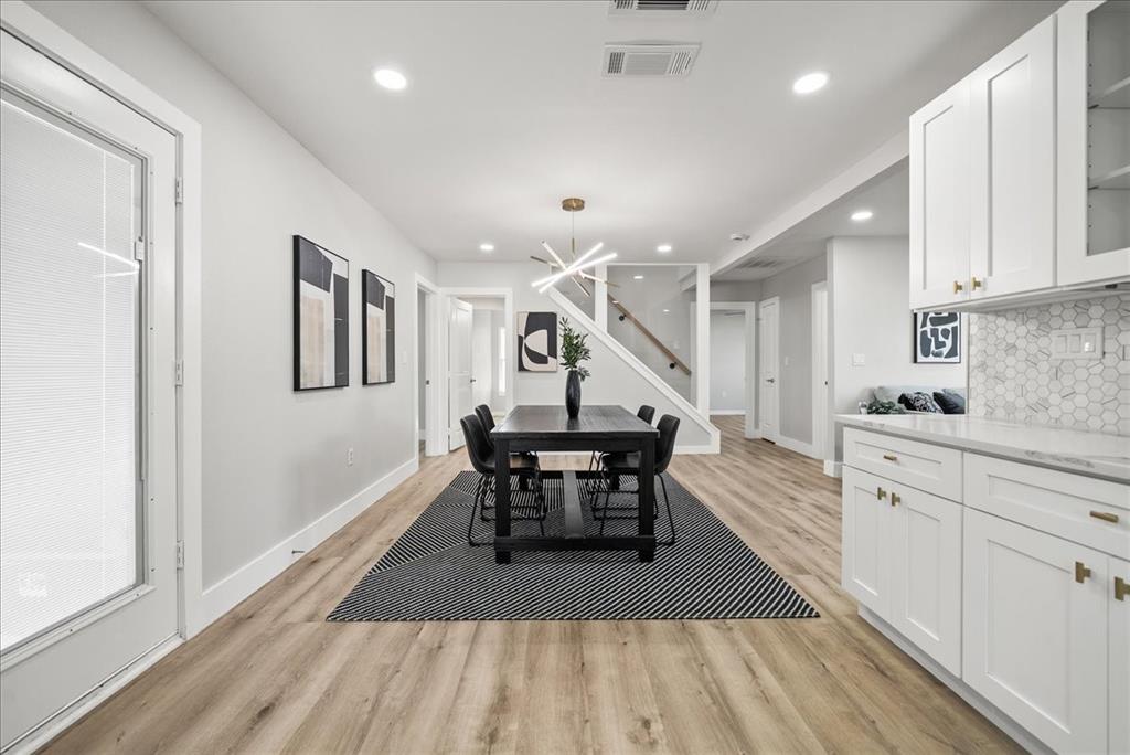 11630 Rupley Lane Dallas, TX 75218 - Photo 11 of 30 a dining hall with stainless steel appliances kitchen island a stove a chimney a sink and a refrigerator