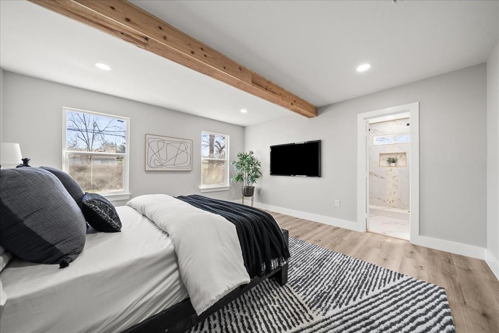 11630 Rupley Lane Dallas, TX 75218 - Photo 13 of 30 a bedroom with a large bed a flat screen tv and a dresser