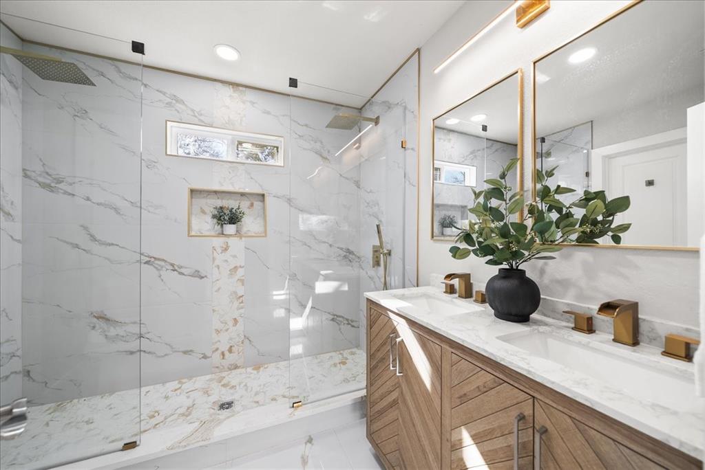 11630 Rupley Lane Dallas, TX 75218 - Photo 14 of 30 a bathroom with a granite countertop sink a mirror and shower