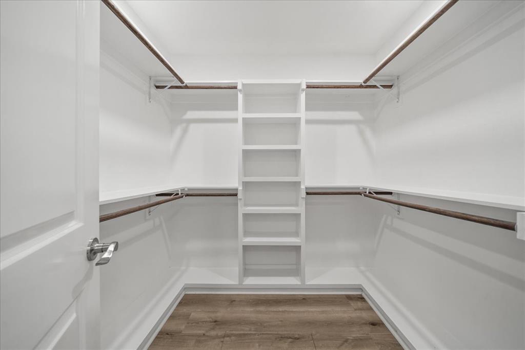 11630 Rupley Lane Dallas, TX 75218 - Photo 17 of 30 a view of walk in closet with empty racks