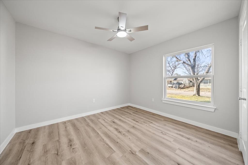 11630 Rupley Lane Dallas, TX 75218 - Photo 19 of 30 wooden floor in an empty room with a window