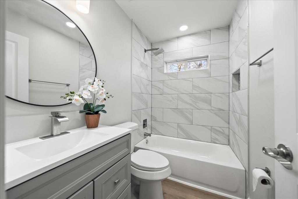 11630 Rupley Lane Dallas, TX 75218 - Photo 20 of 30 a bathroom with a sink a toilet and shower