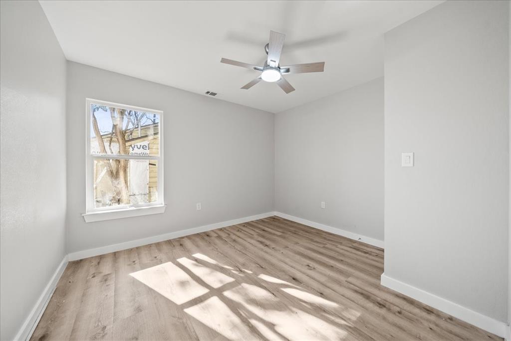 11630 Rupley Lane Dallas, TX 75218 - Photo 21 of 30 wooden floor in an empty room with a window
