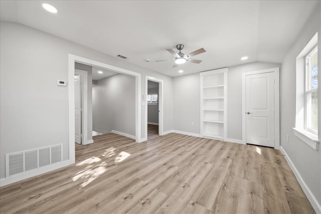 11630 Rupley Lane Dallas, TX 75218 - Photo 22 of 30 a view of empty room with wooden floor and window