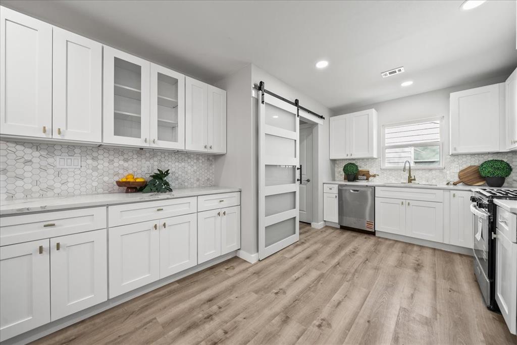 11630 Rupley Lane Dallas, TX 75218 - Photo 9 of 30 a kitchen with white cabinets and white appliances