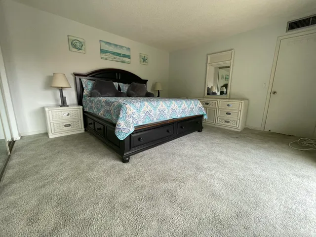 a bedroom with a bed and a cabinets