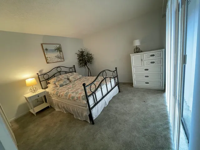 a spacious bedroom with a bed and a window