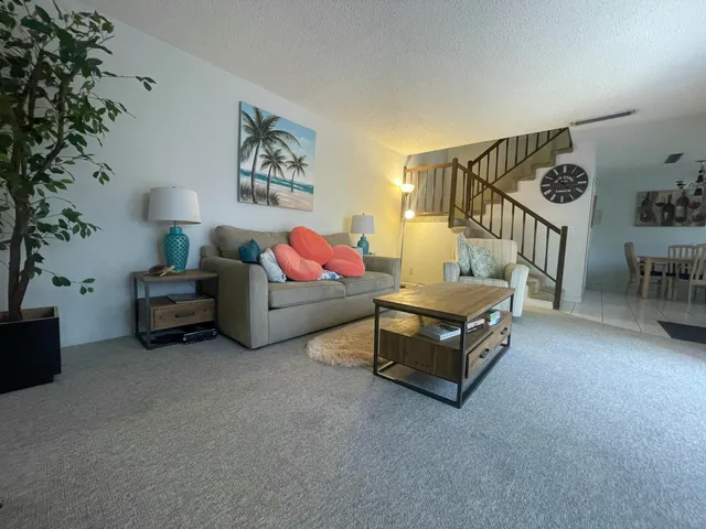 a living room with furniture and a potted plant