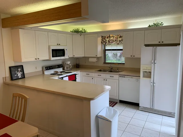a kitchen with cabinets a sink and appliances