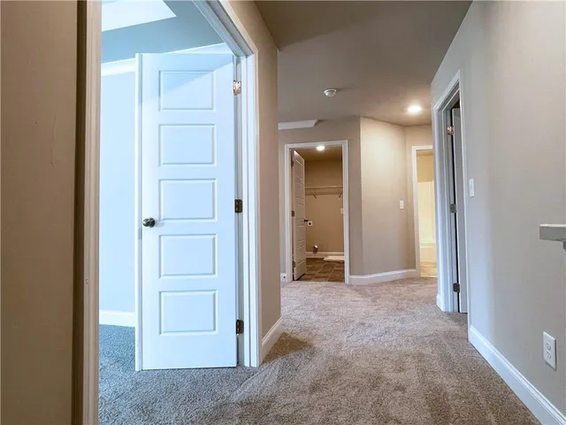 an empty room with closet and a bathroom