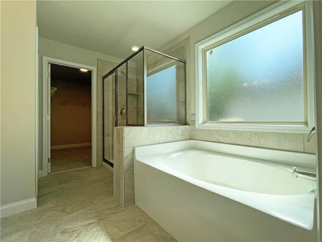 a bathroom with a tub and shower