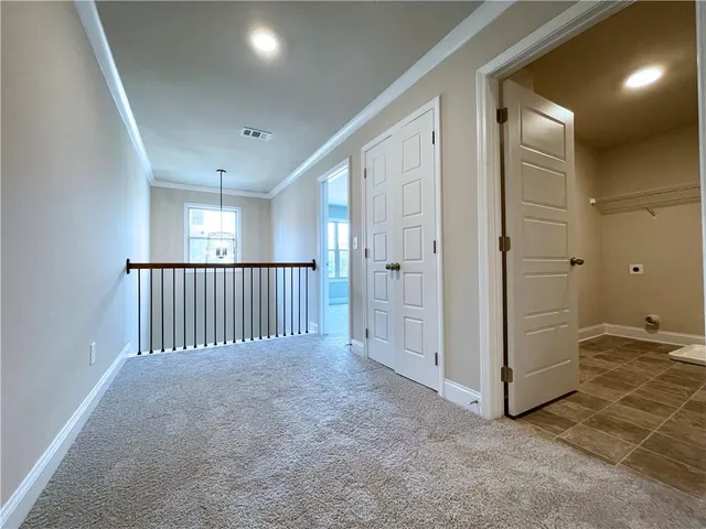 an empty room with windows and stairs