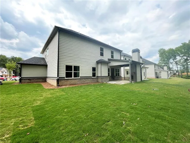a front view of house with yard and green space