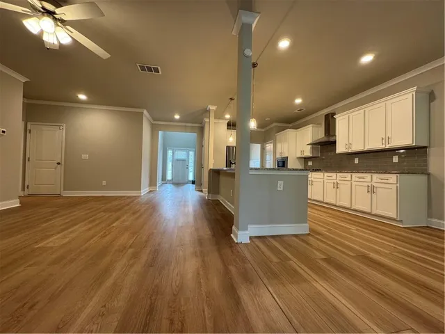 a view of kitchen with cabinets appliances and wooden floor