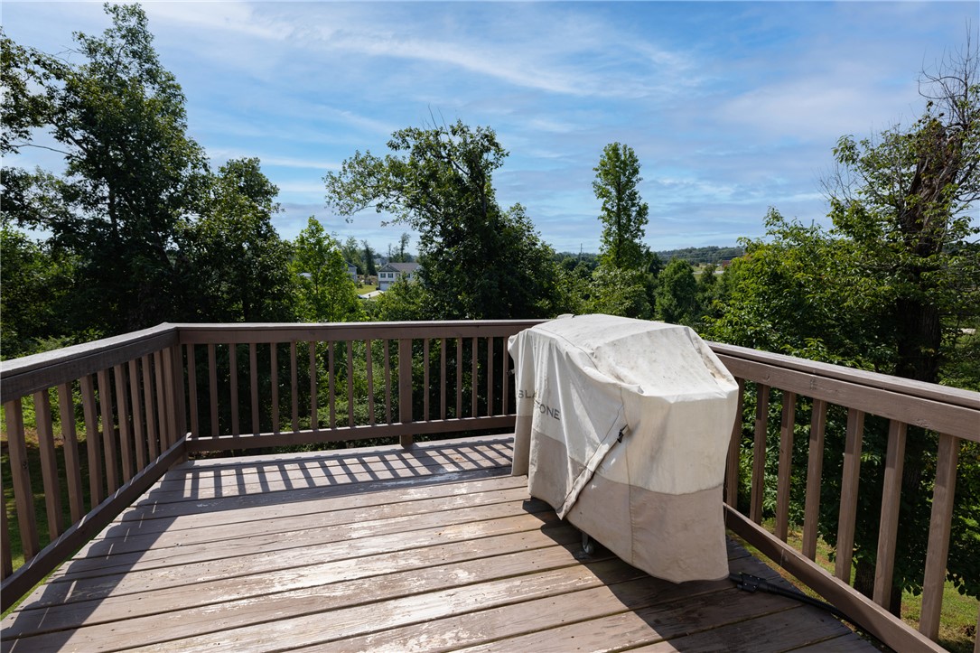 768 Rocky Ridge Circle Seneca, SC 29678 - Photo 21 of 30 An elevated wooden deck offers a scenic overlook of the surrounding natural landscape and distant neighborhood.