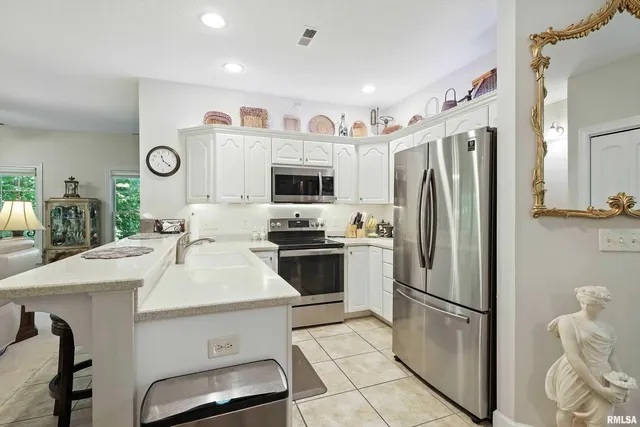 a kitchen with a refrigerator a oven and a sink