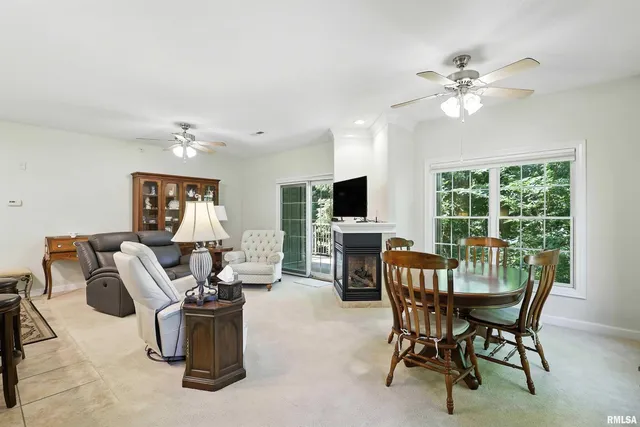 a view of a dining room with furniture a chandelier and window