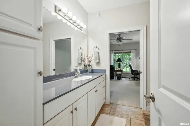 a en suite bathroom with a double vanity sink and a mirror