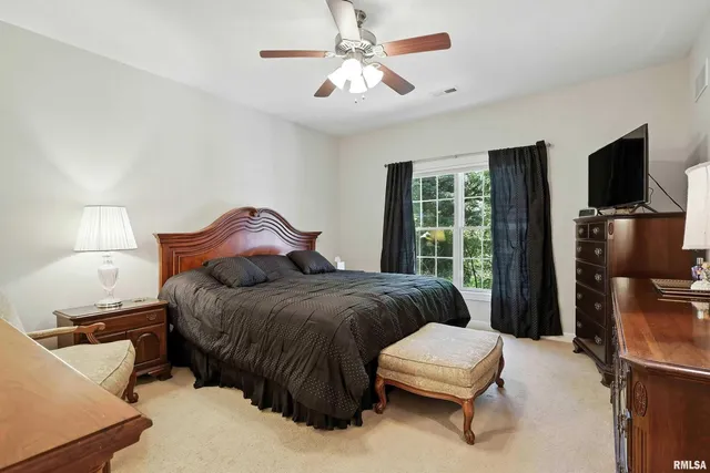 a bedroom with a bed and a television