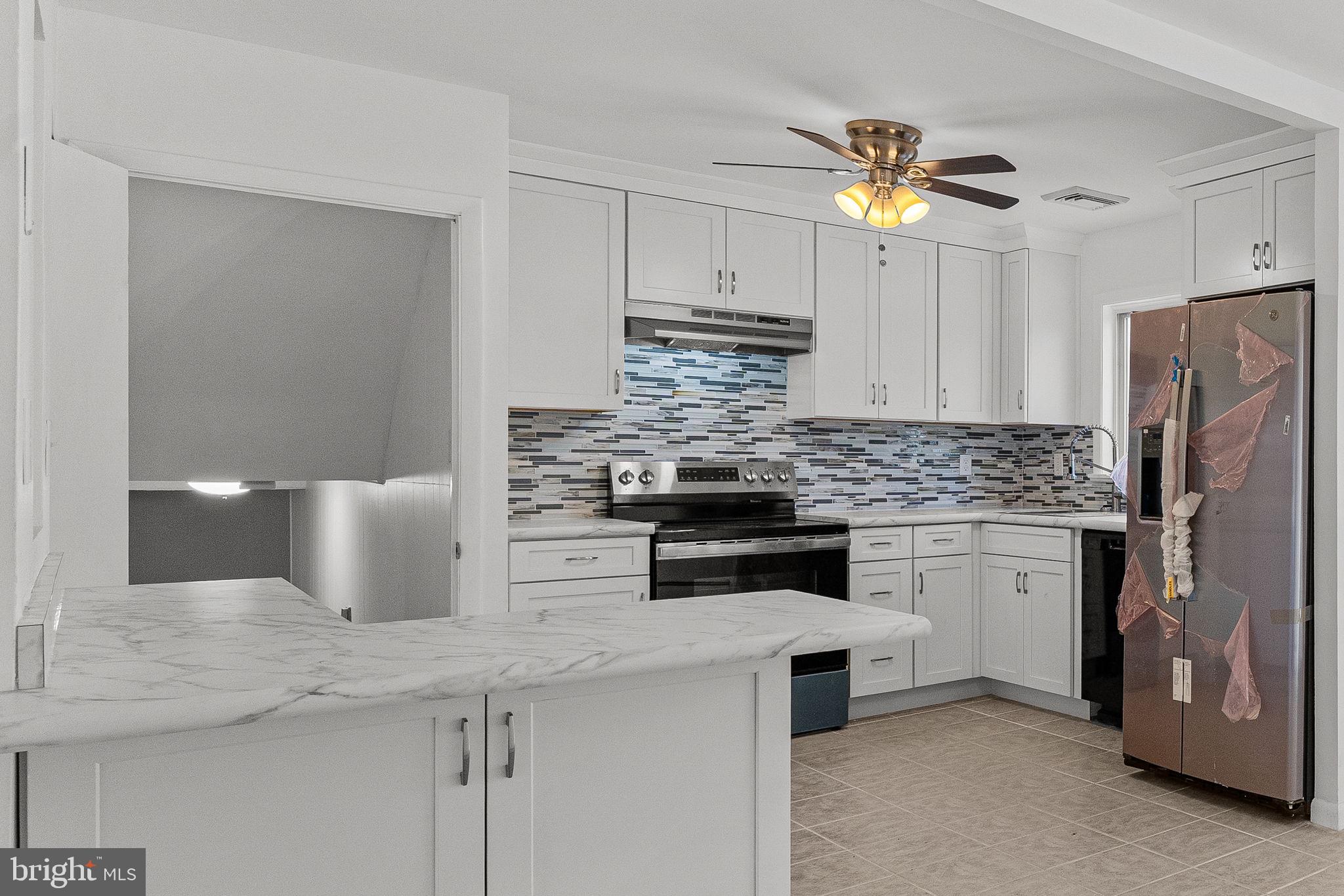 1687 Rupert Road Pottstown, PA 19464 - Photo 8 of 33 a kitchen with stainless steel appliances a sink and a refrigerator