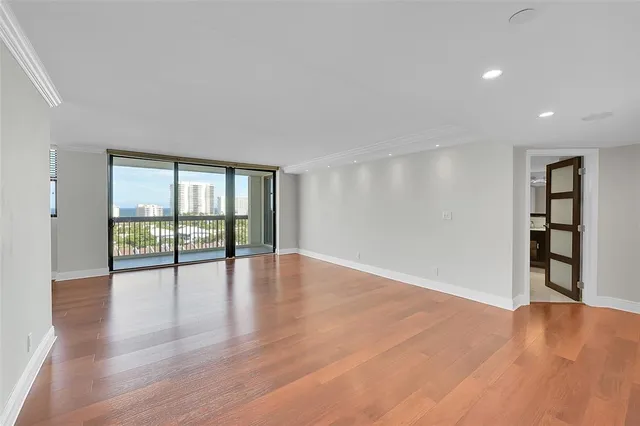 a view of wooden floor and windows in a room
