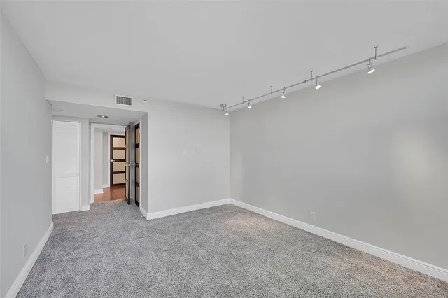 a bathroom with a toilet a sink a mirror and a shower