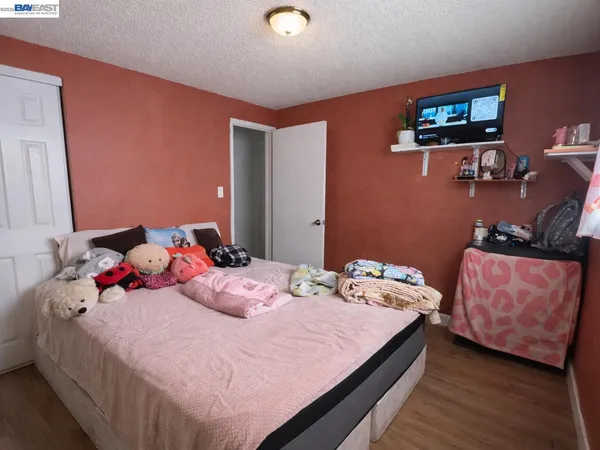 a bedroom with a bed and a tv