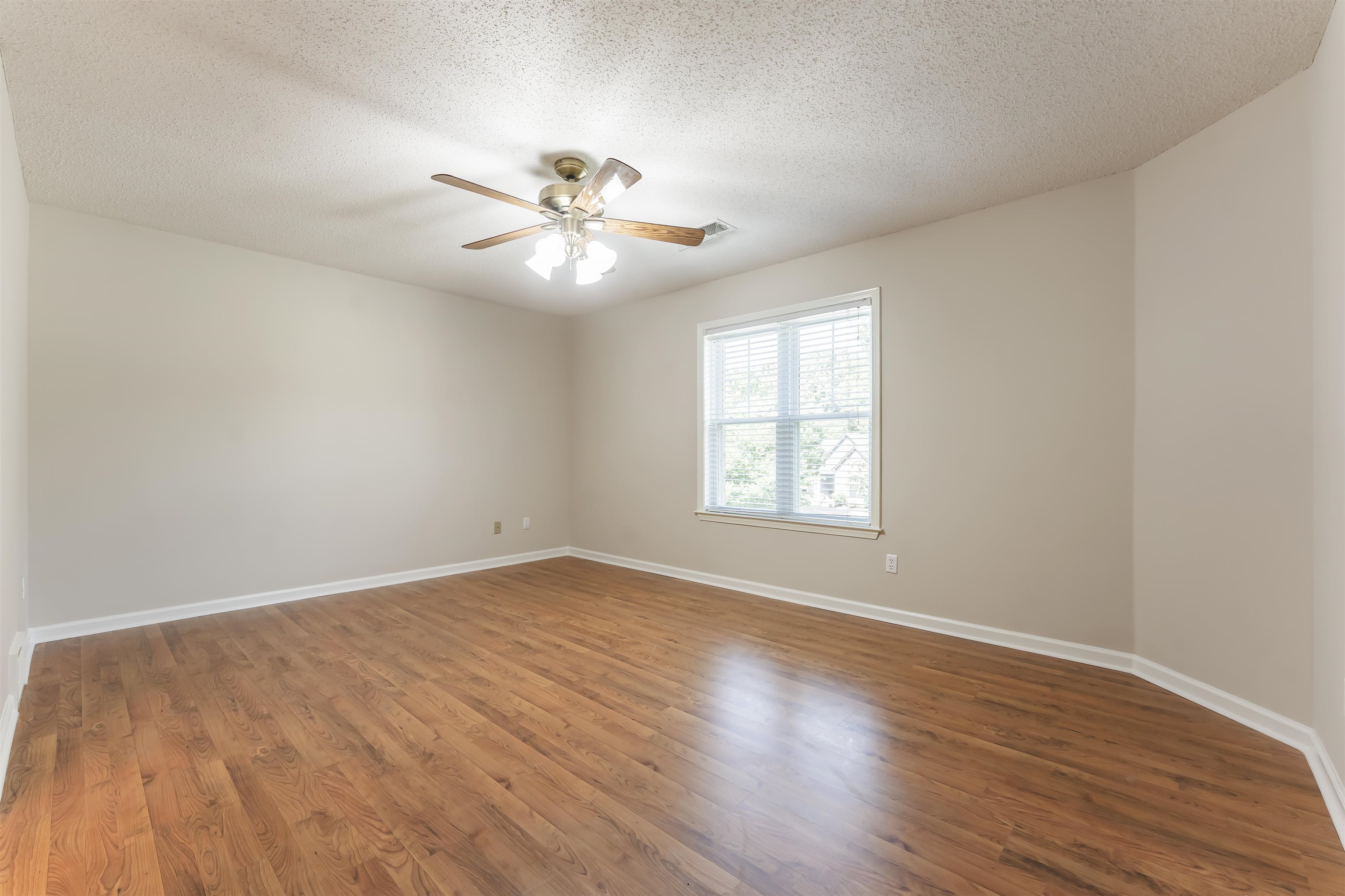 4279 High Plains Road Bartlett, TN 38135 - Photo 22 of 37 Spacious room featuring wood-finish flooring, neutral-toned walls, and a window with blinds
