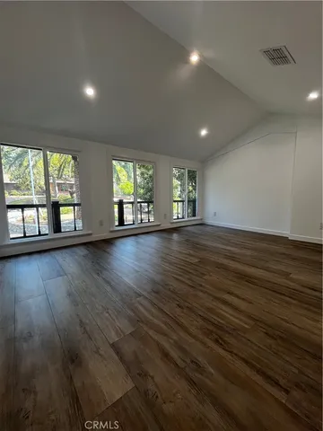 a view of a room with wooden floor and window