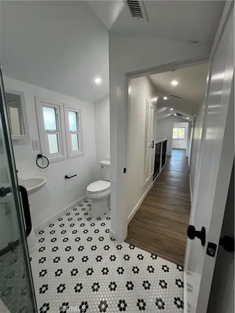 a bathroom with a sink toilet and mirror