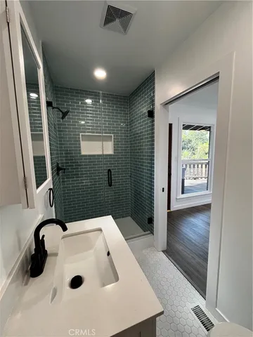 a bathroom with a tub sink and mirror