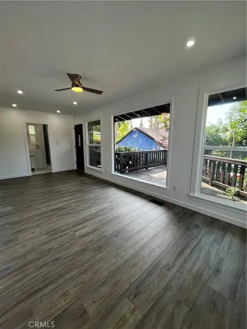 a view of balcony with wooden floor and outdoor seating