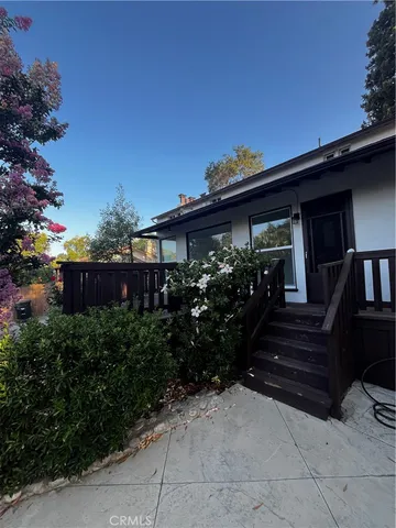 a backyard of a house with plants and tree