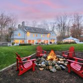 a view of a house with backyard sitting area and garden
