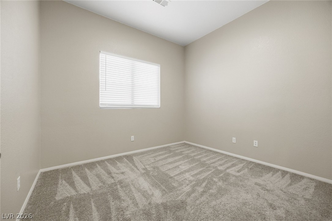 193 Oella Ridge Court Henderson, NV 89012 - Photo 23 of 32 An inviting room, ready for personal touches, features a wide window and soft carpeting.