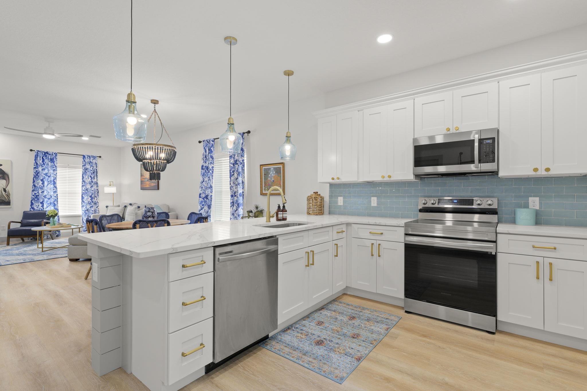 160 Blanco Street St. Augustine, FL 32084 - Photo 43 of 43 a kitchen with a sink stove and microwave