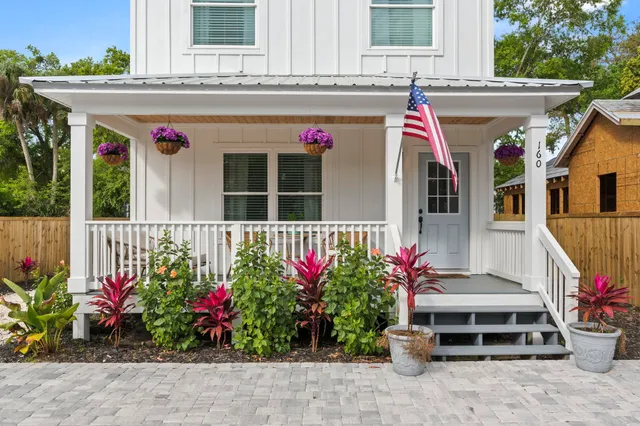 a view of a house that has a flower garden
