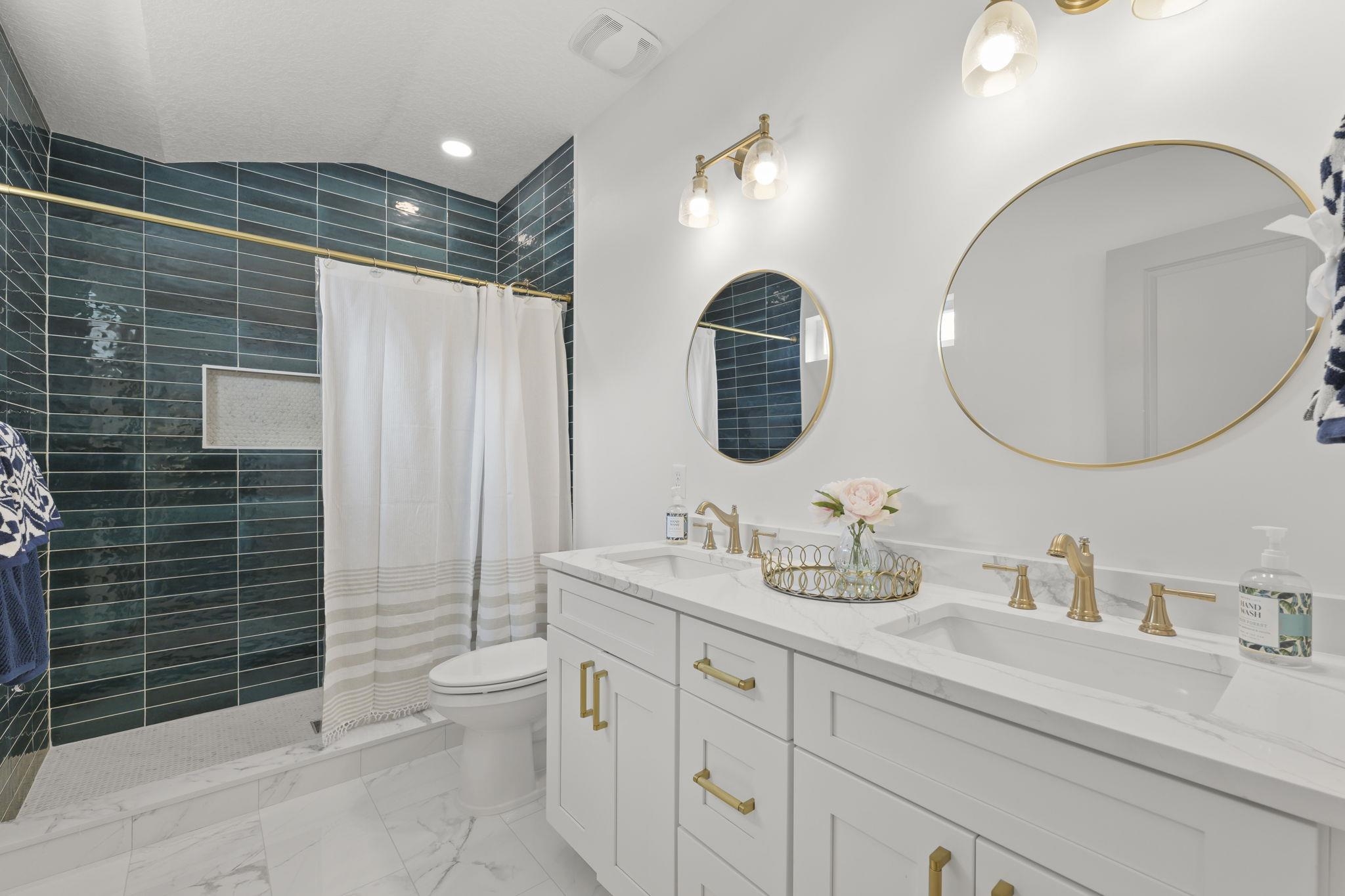 160 Blanco Street St. Augustine, FL 32084 - Photo 32 of 43 a bathroom with a double vanity sink toilet and a mirror