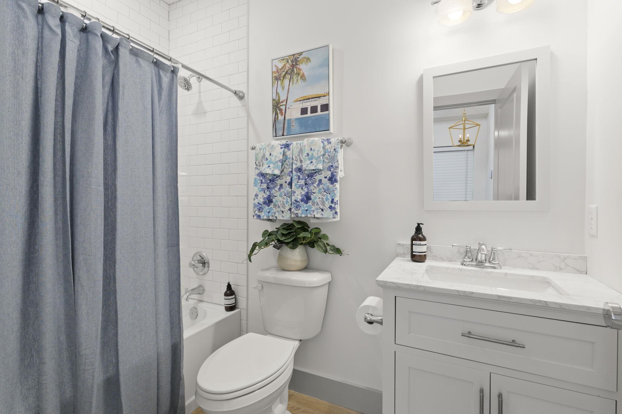 160 Blanco Street St. Augustine, FL 32084 - Photo 36 of 43 a bathroom with a toilet a sink and a mirror
