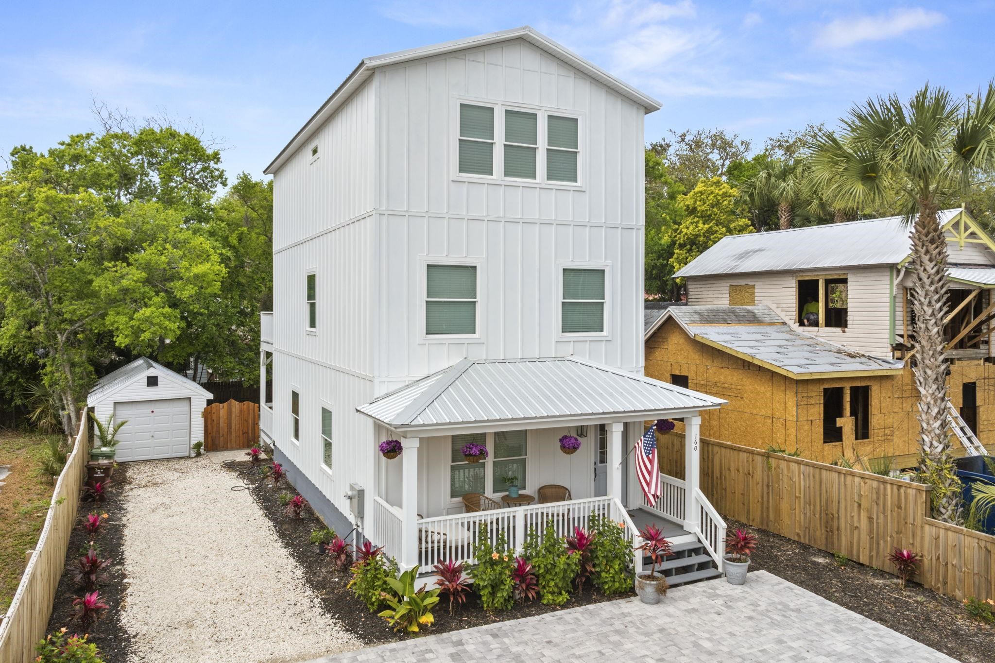 160 Blanco Street St. Augustine, FL 32084 - Photo 42 of 43 a view of a white house with large windows and a small yard